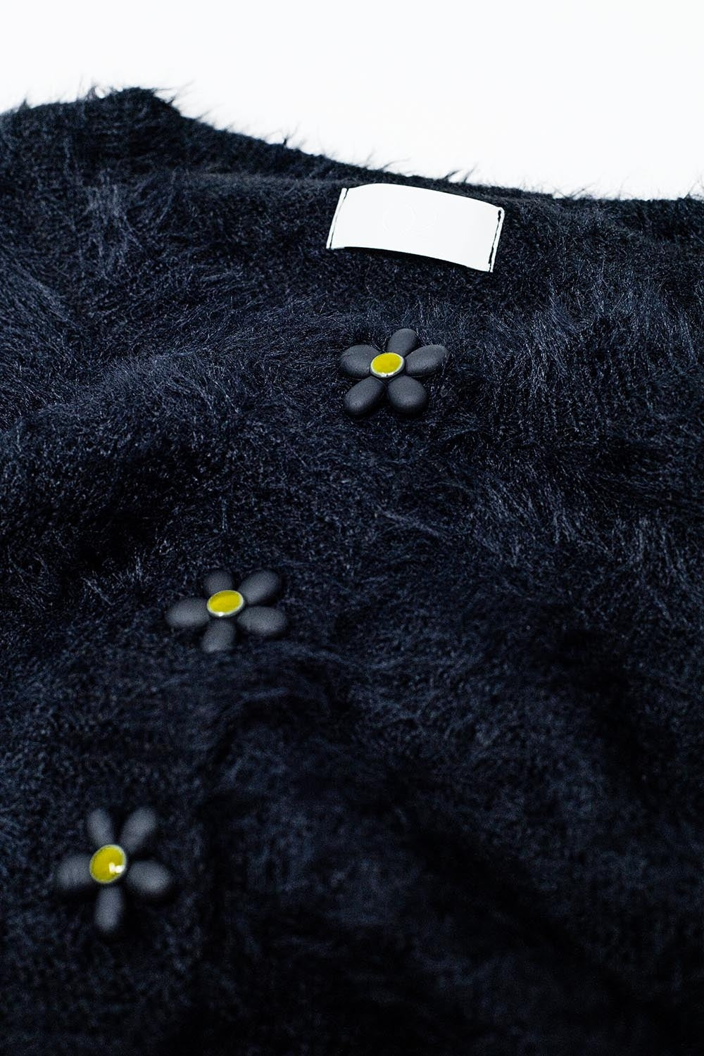 Cardigan nero corto e soffice con bottoni a fiore