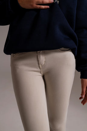 Jeans alla caviglia beige con pieghe morbide