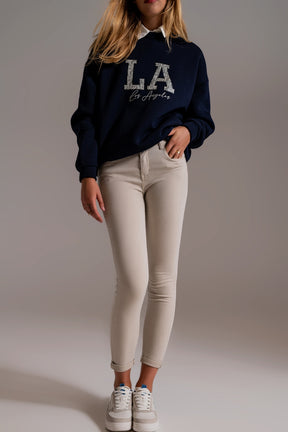 Jeans alla caviglia beige con pieghe morbide