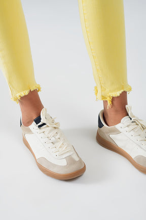 Jeans stretch super skinny gialli con orlo frastagliato