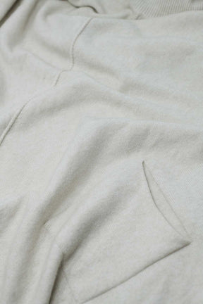 Maglione beige oversize con tasche frontali