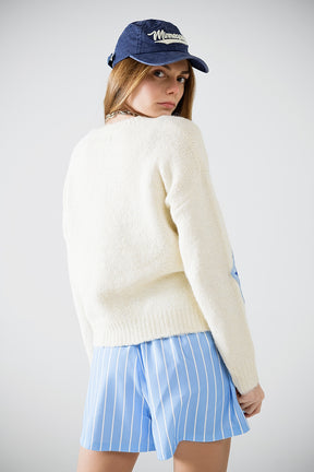 Maglione crema con stelle ricamate