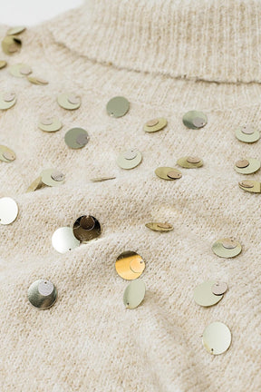 Maglione dolcevita beige con dettagli in paillettes