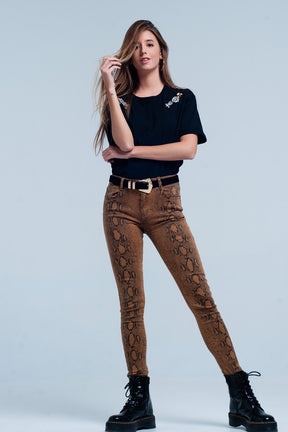 Pantalone skinny arancione in stampa serpente