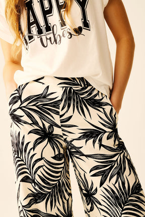 Pantaloni a Gamba Larga in Bianco con Dettaglio Floreale in Nero