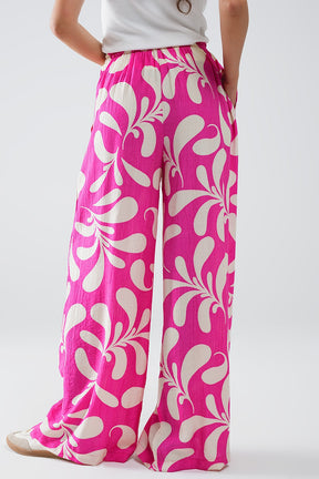 Pantaloni a gamba tesa con vita elasticizzata e stampa floreale fucsia