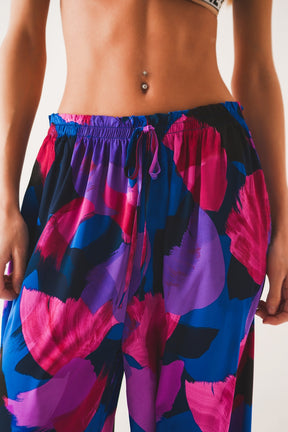 Pantaloni taglio ampio con motivo floreale viola