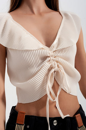 Top corto allacciato sul davanti con arricciature e maniche voluminose color crema